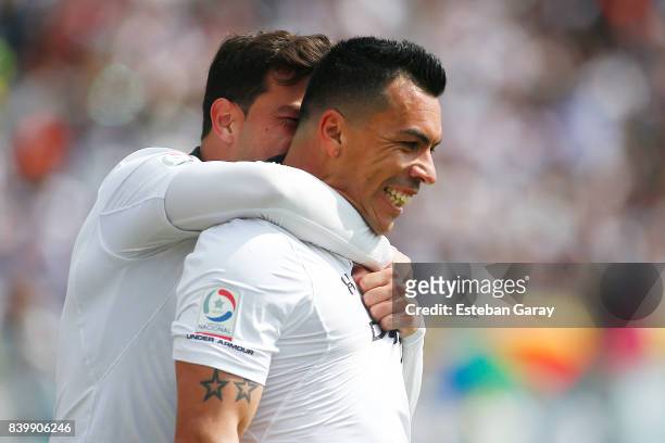 Esteban Paredes of Colo-Colo celebrates with teammate after scoring the third goal of his team during a match between Colo-Colo and U de Chile as...