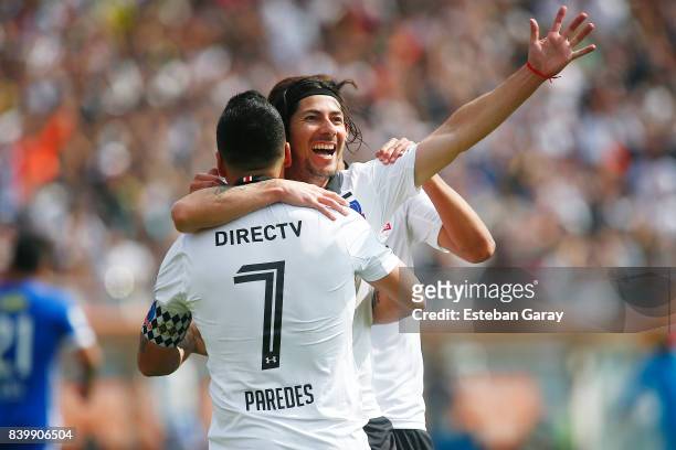Esteban Paredes of Colo-Colo celebrates with teammate Jaime Valdes after scoring the third goal of his team during a match between Colo-Colo and U de...