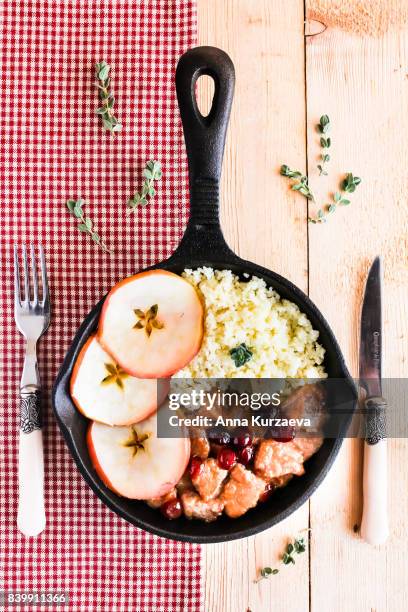 pork stew with dried cranberry served with couscous in a pan, selective focus - homemade apple sauce stock pictures, royalty-free photos & images