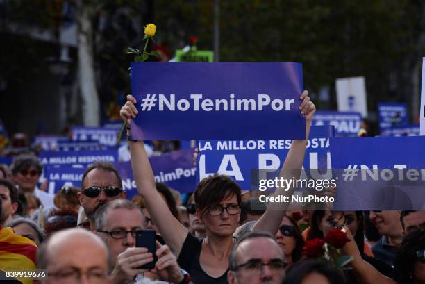 Woman holds a placard reading &quot;The best answer, peace&quot;during a march against terrorism which slogan will be #NoTincPor in Barcelona on...