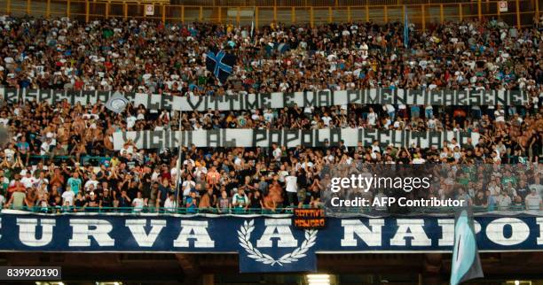 Fans hold a banner in tribute to the victims of the earthquake in Ischia island during the Italian Serie A football match SSC Napoli vs Atalanta BC...