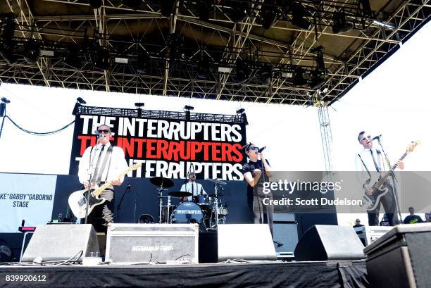 Musicians Kevin Bivona, Jesse Bivona, Aimee Allen and Justin Bivona of the band The Interrupters perform onstage during the Its Not Dead 2 Festival...