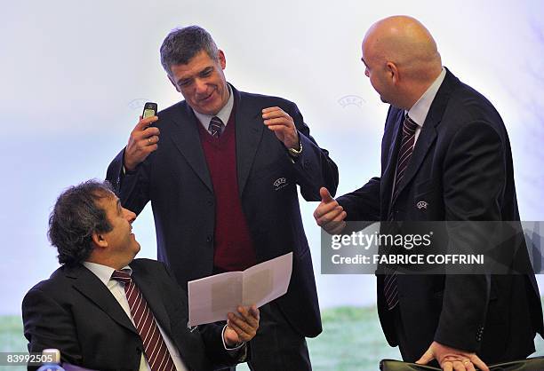 Executive Committee member Angel Maria Villar Llona of Spain gestures with UEFA President Michel Platini and deputy Chief Executive Gianni Infantino...