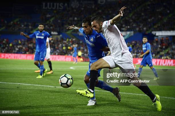 Sevilla's midfielder Pablo Sarabia vies with Getafe's Uruguayan defender Damian Suarez during the Spanish league football match Getafe CF vs Sevilla...