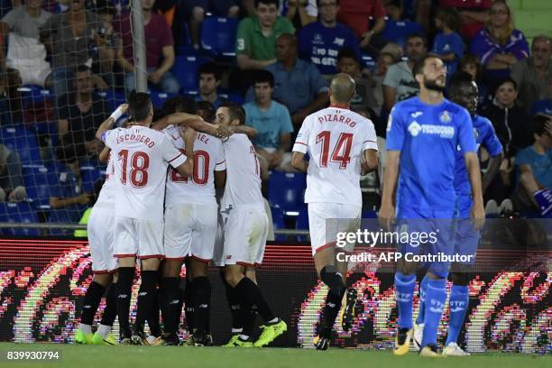 Sevilla players celebrate after scoring during the Spanish league football match Getafe CF vs Sevilla FC at the Coliseum Alfonso Perez stadium in...