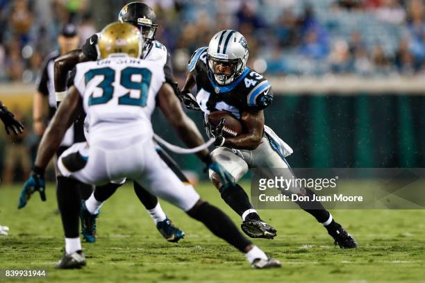 Runningback Fozzy Whittaker of the Carolina Panthers on a running play during the game against the Jacksonville Jaguars at EverBank Field on August...