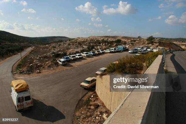 Palestinian cars driving on the road between Qaffin and Yabed pass under the Israeli settlers' road that connects October 30, 2008 the settlements of...