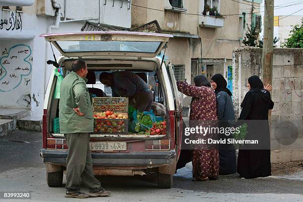 Palestinian farmers sell their produce from the back of a van in the Palestinian village of Nazlat Issa October 30, 2008 near Qaffin in the West...