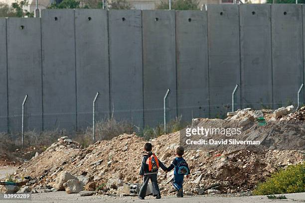 Young Palestinian boys walk home from school on what was once a major road from Israel into the West Bank until the Jewish State built it's...