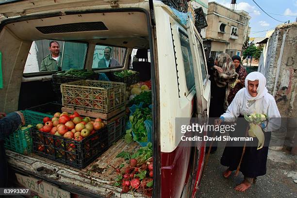 Palestinian farmers sell their produce from the back of a van in the Palestinian village of Nazlat Issa October 30, 2008 near Qaffin in the West...