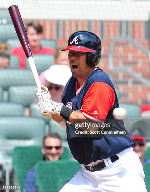 Kurt Suzuki of the Atlanta Braves is hit by a fourth inning pitch against the Colorado Rockies at SunTrust Park on August 27, 2017 in Atlanta,...