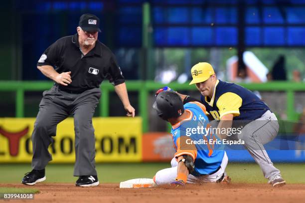 Mike Aviles of the Miami Marlins is tagged out at second base by Dusty Coleman of the San Diego Padres in the seventh inning of the game at Marlins...