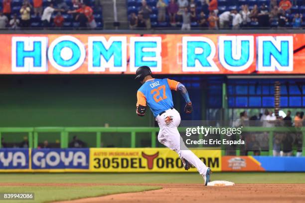 Giancarlo Stanton of the Miami Marlins rounds second base after hitting his 50th home run of the season in the eighth inning against the San Diego...