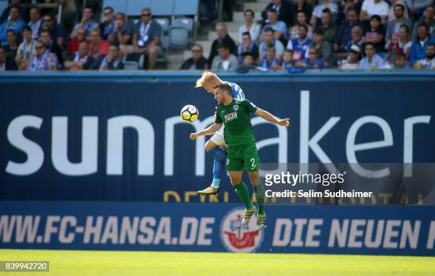 Marcel Hilsner of Hansa Rostock fights for the ball with Stephane Tritz of Preussen Muenster during the 3. Liga match between F.C. Hansa Rostock and...