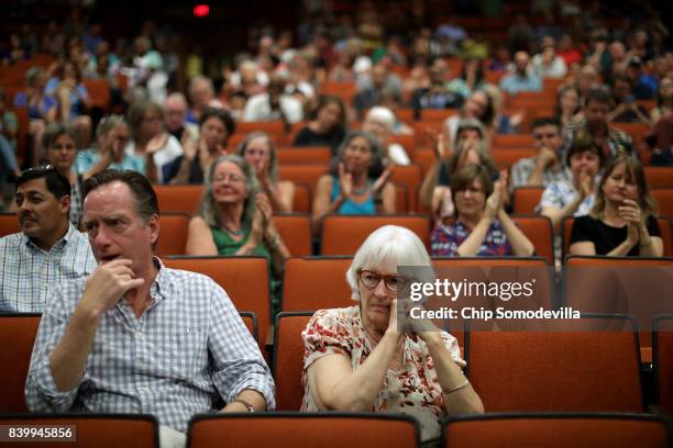 Residents attend a 'community recovery' town hall meeting conducted by the Department of Justice's Community Relations Service at the Dr. Martin...