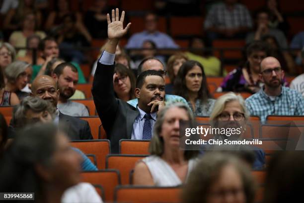 Charlottesville City Manager Maurice Jones raises his hand to confirm that he invited the Department of Justice's Community Relations Service to...