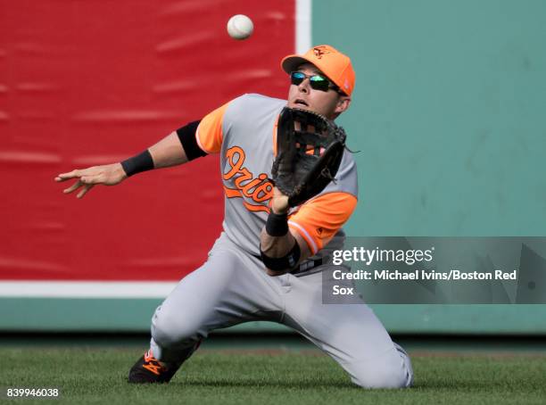 Seth Smith of the Baltimore Orioles makes a catch against Eduardo Nez of the Boston Red Sox in the eighth inning at Fenway Park on August 27, 2017 in...