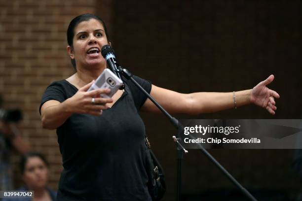 Resident Louisa Candelario speaks during a 'community recovery' town hall meeting conducted by the Department of Justice's Community Relations...