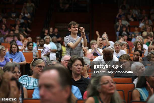 Residents attend a 'community recovery' town hall meeting conducted by the Department of Justice's Community Relations Service at the Dr. Martin...