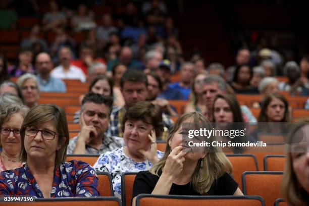 Residents attend a 'community recovery' town hall meeting conducted by the Department of Justice's Community Relations Service at the Dr. Martin...