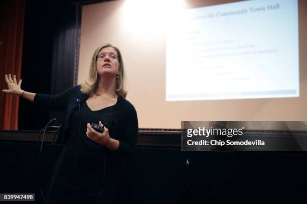 Department of Justice's Community Relations Service Conciliation Specialist Suzanne Buchanan conducts a 'community recovery' town hall meeting at the...