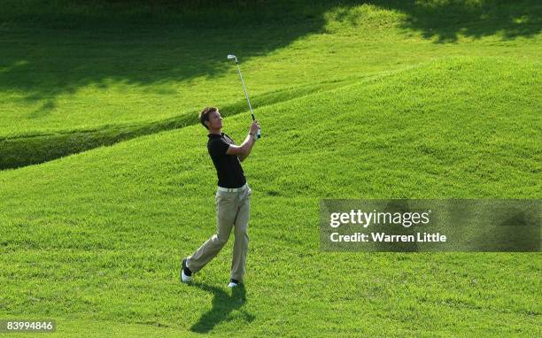 Chris Wood of England plays his second shot into the 14th green during the first round of the Alfred Dunhill Championship at Leopard Creek Country...