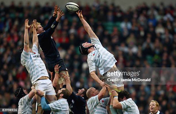 Ian Kench of Oxford jumps in the line out with Martin Wilson and Daniel Vickerman of Cambridge during the Varsity Rugby Match between Oxford...
