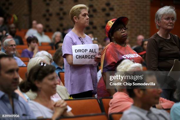 Residents attend a 'community recovery' town hall meeting conducted by the Department of Justice's Community Relations Service at the Dr. Martin...