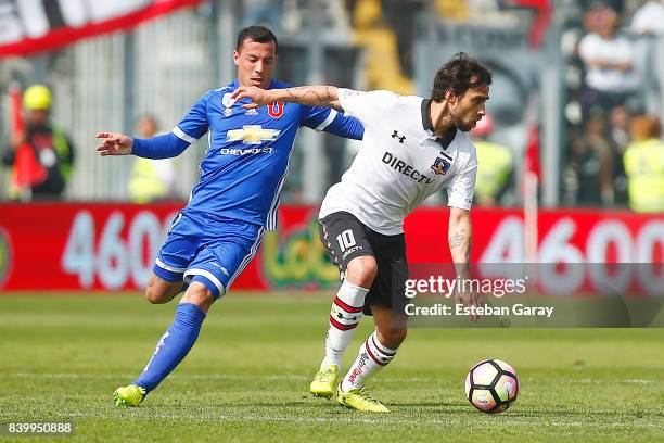 Jorge Valdivia of Colo-Colo struggles for the ball with Sebastian Ubilla of U de Chile during a match between Colo-Colo and Universidad de Chile as...