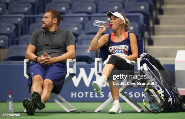 Caroline Wozniacki of Denmark with her boyfriend American profesional basketball player David Lee during a practice session prior to the US Open...