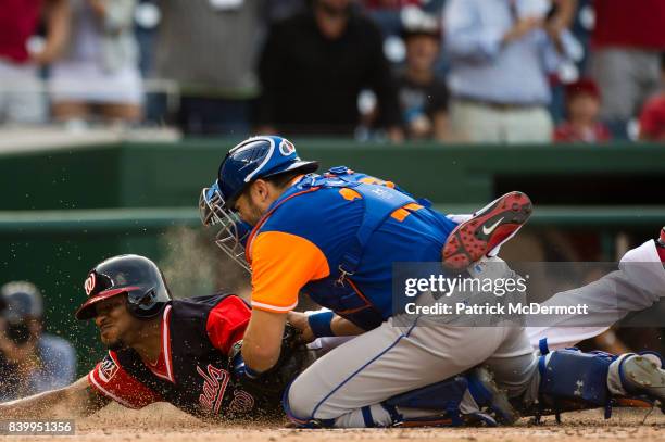 Edwin Jackson of the Washington Nationals is tagged out at home plate by Travis d'Arnaud of the New York Mets in the ninth inning during Game One of...