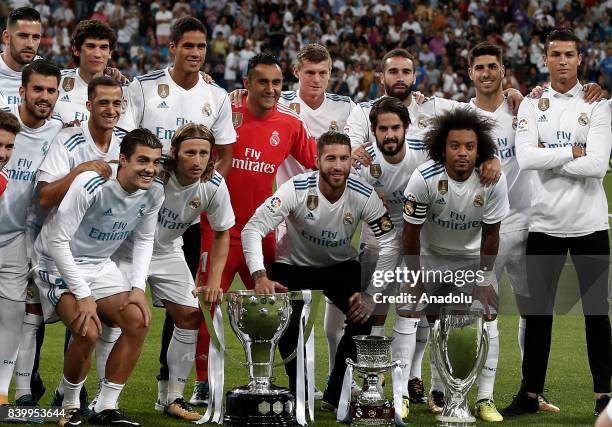 Players of Real Madrid pose for a photo with their 2016/2017 Champions League, La Liga and Bernabeu trophies ahead of La Liga soccer match between...