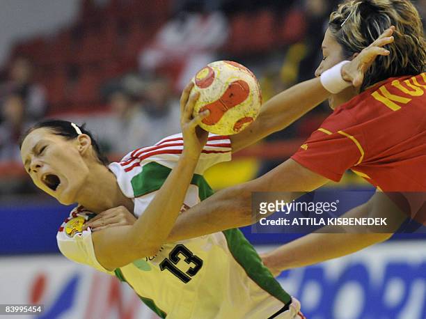 Hungarian Anita Goerbicz is fouled by Spanish Zornitza Koleva during the 8th Women's Handball European Championships match on December 11, 2008 in...