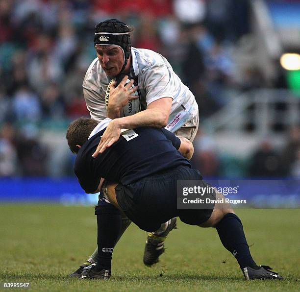Dan Vickerman of Cambridge University is tackled by Peter Clarke during the varsity match between Oxford University and Cambridge University at...