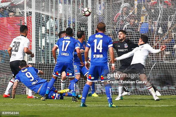 Mauricio Pinilla of U de Chile kicks the ball to score the first goal of his team during a match between Colo-Colo and U de Chile as part of Torneo...