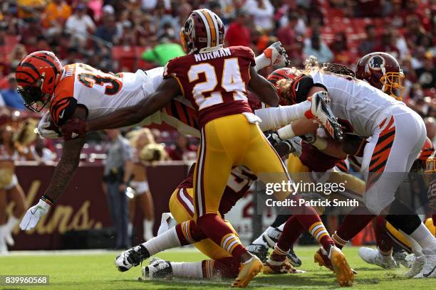 Running back Jeremy Hill of the Cincinnati Bengals leaps into the end zone for a touch down in front of cornerback Josh Norman of the Washington...