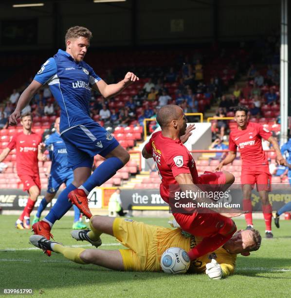 Goalkeeper Graham Stack of Eastleigh dives at the feet of Jake Caprice of Leyton Orient during the National League match between Leyton Orient and...