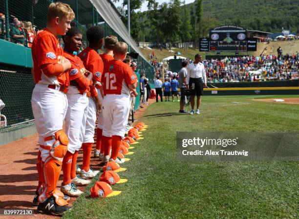 Members of the Southwest team from Texas are seen outside the dugout during the singing of national anthems prior to the Championship game of the...