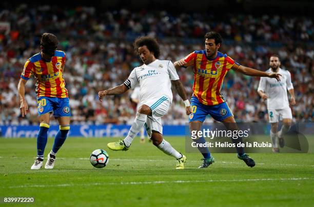 Marcelo of Real Madrid and Dani Parejo , Nacho Vidal of Valencia cf compete for the ball during the La Liga match between Real Madrid and Valencia CF...