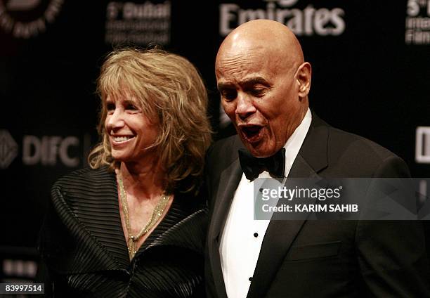 Singer Harry Belafonte with his wife Pamela stand on the red carpet on the opening night of the Dubai International Film Festival's fifth edition in...