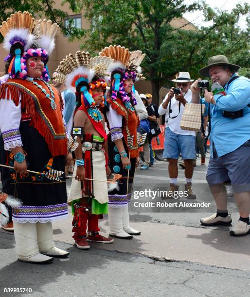 Young Native American members of the Edaakie Junior Dance Group from Zuni Pueblo near Gallup, New Mexico, pose for photographs at the Santa Fe Indian...
