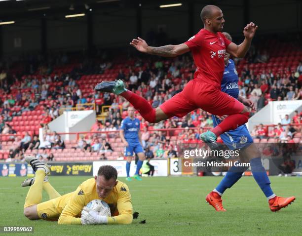 Graham Stack of Eastleigh dives at the feet of Jake Caprice of Leyton Orient during the National League match between Leyton Orient and Eastleigh at...
