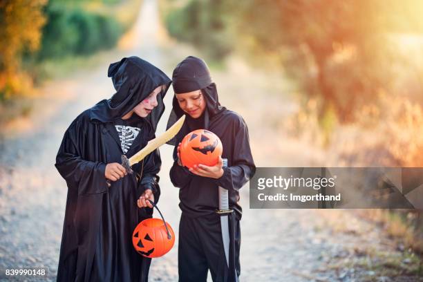 little halloween boys comparing amount of candy - ninja kid stock pictures, royalty-free photos & images