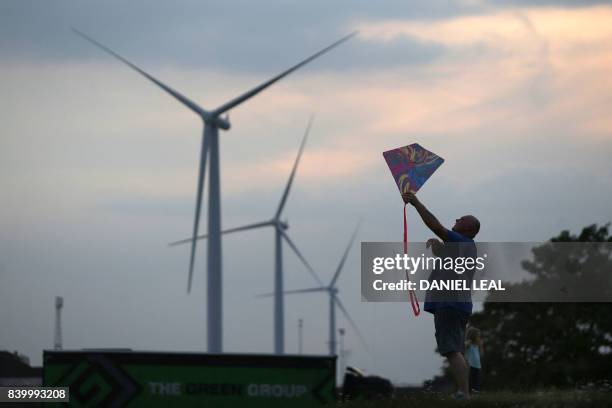 Man, with his daughter, flies a kite at the Tilbury Fort in the dock town of Tilbury in Essex, east of London on August 26, 2017. In the run down...