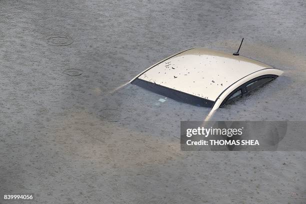 Submerged car is seen on Interstate 610 North on August 27, 2017 in Houston as the city battles with tropical storm Harvey and resulting floods.