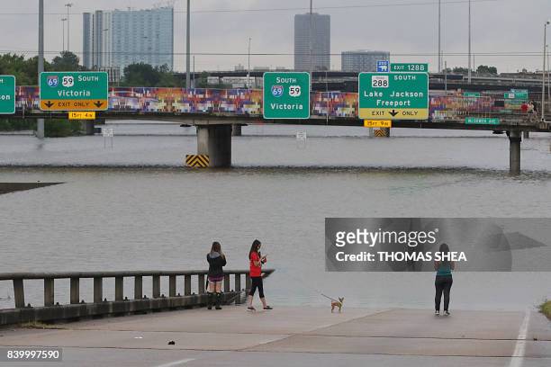 People view the flooded highways in Houston on August 27, 2017 as the city battles with tropical storm Harvey and resulting floods. - Massive...