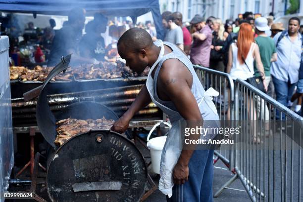 Street vendor cooks jerk chicken on first day of the Notting Hill Carnival in West London, United Kingdom on August 27, 2017. Nearly one million...