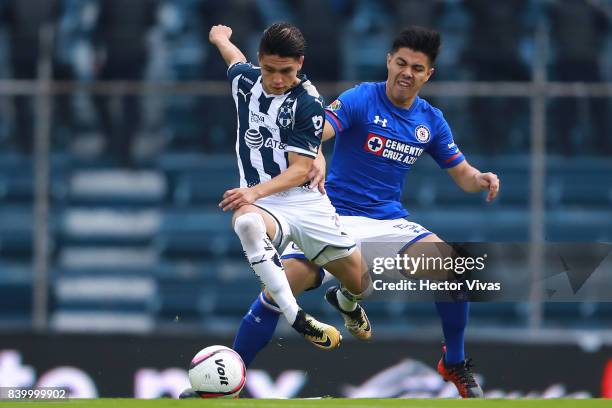 Jonathan Gonzalez of Monterrey struggles for the ball with Francisco Silva of Cruz Azul during the seventh round match between Cruz Azul and...