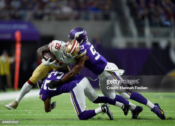 Carlos Hyde of the San Francisco 49ers is tackled by Terence Newman and Danielle Hunter of the Minnesota Vikings during the first quarter in the...