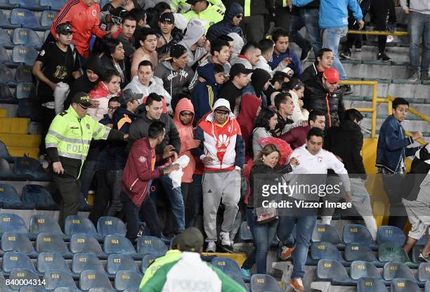 Fans leave the stands after being hitted with a flare during a match between Independiente Santa Fe and Millonarios as part of Liga Aguila II 2017 at...
